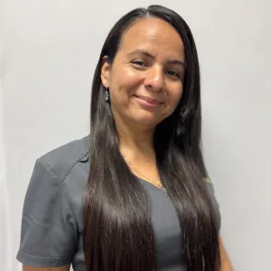 emily has dark hair and is smiling wearing a merry maids uniform